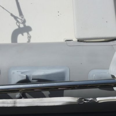 Looking down on the dinghy during carriage, one can see the 2 Velcro straps onto the Transverse Link, and the webbing harness lateral attachment clip.
